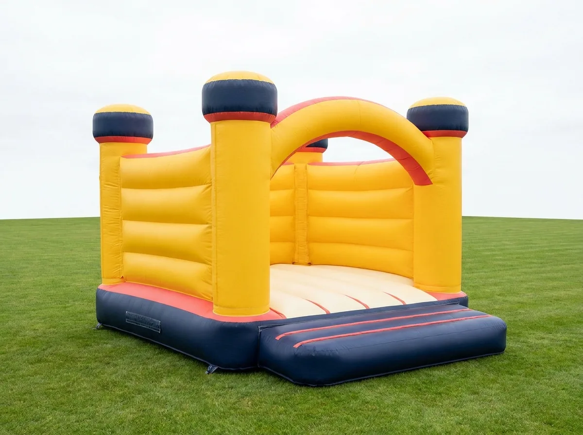 Large adult-capable bouncy castle in yellow with navy base and coral trim