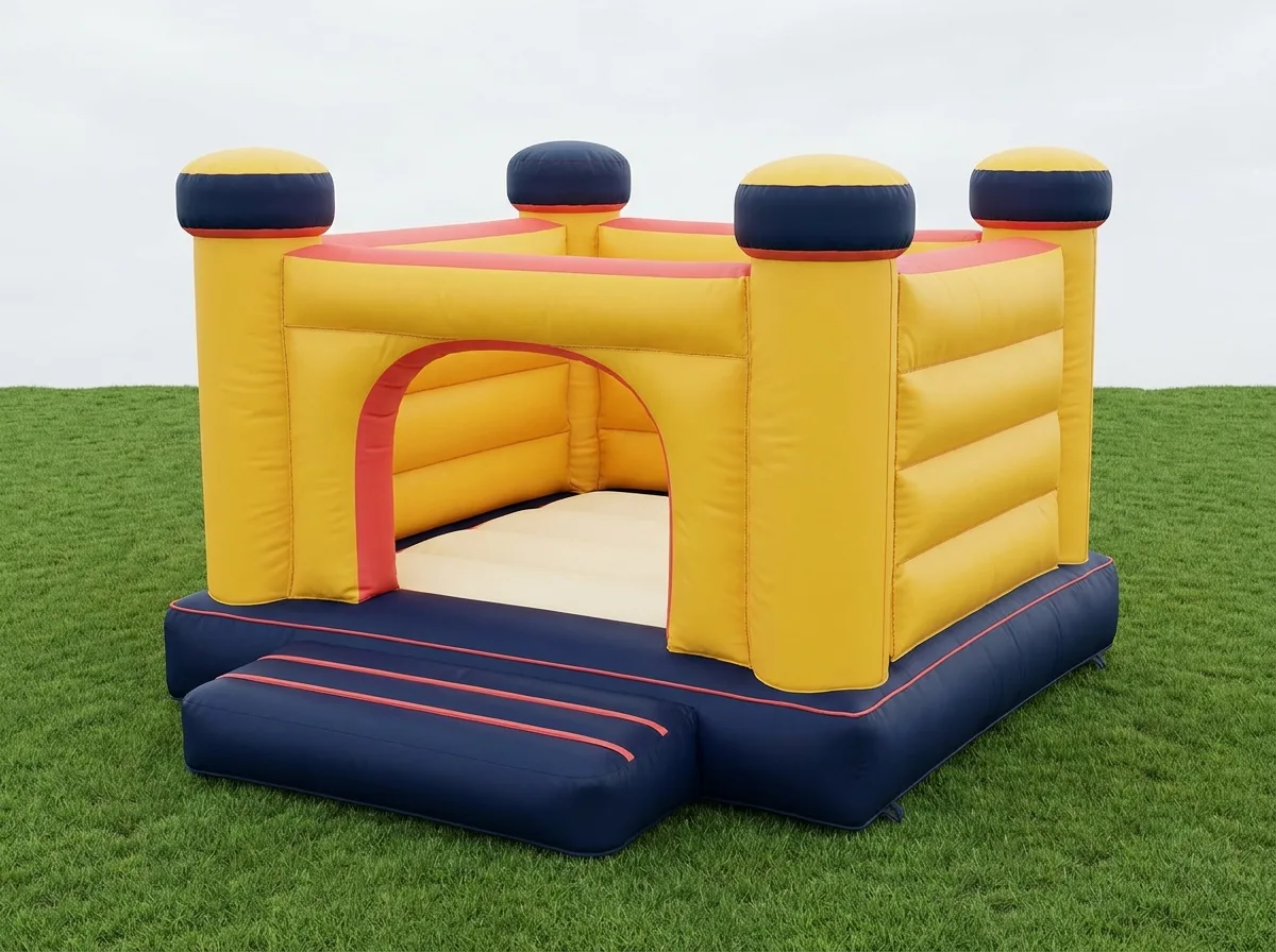 Standard bouncy castle in yellow with navy turrets and coral trim on grass